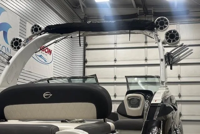 Slide: The Image of 2019 Crownline Eclipse E255 SURF boat in showroom, featuring sleek design and modern amenities. - 34