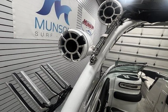 Slide: The Image of 2019 Crownline Eclipse E255 SURF boat with speakers and wakeboard rack in showroom. - 36