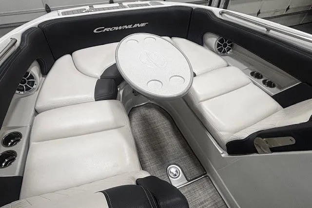 Slide: The Image of 2019 Crownline Eclipse E255 SURF boat interior with white seating and round table. - 4