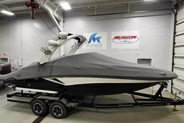 Slide: The Image of 2019 Crownline Eclipse E255 SURF boat covered in a garage, on a trailer. - 48