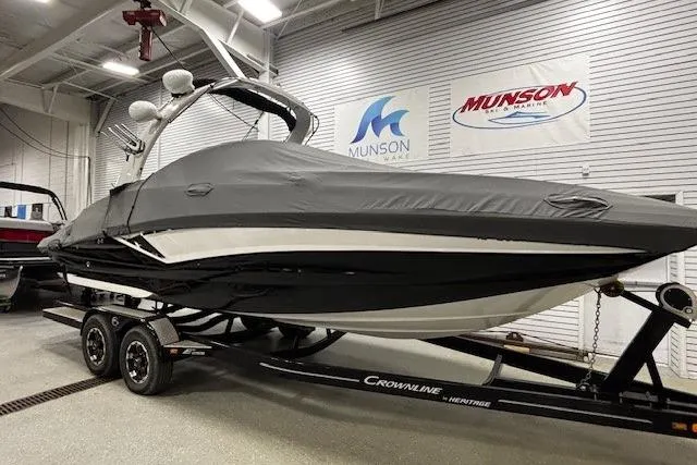 Slide: The Image of 2019 Crownline Eclipse E255 SURF boat covered, on trailer in showroom. - 49