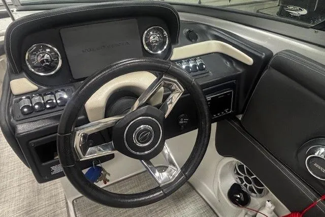 Slide: The Image of 2019 Crownline Eclipse E255 SURF boat dashboard with steering wheel and control panel. - 5