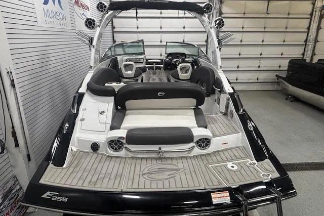 Slide: The Image of 2019 Crownline Eclipse E255 SURF boat interior with seating and speakers in a showroom. - 7