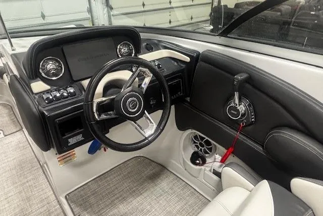 Slide: The Image of 2019 Crownline Eclipse E255 SURF boat interior with steering wheel and control panel. - 9