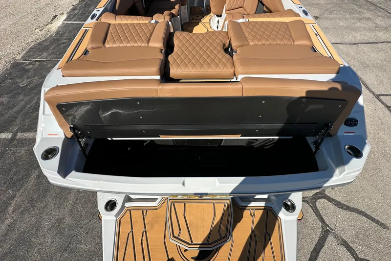Slide: The Image of 2026 Tigé Z3 boat interior with tan leather seats and open storage compartment. - 10