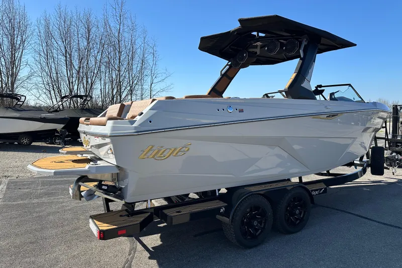 Slide: The Image of 2026 Tigé Z3 boat on trailer, parked outdoors under clear blue sky. - 3