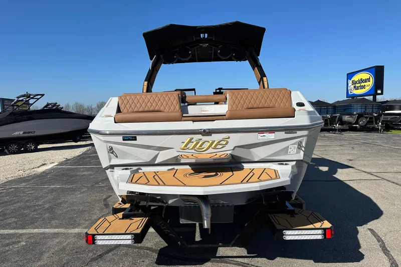 Slide: The Image of 2026 Tigé Z3 boat with tan seating, displayed at Blackbeard Marine dealership. - 4