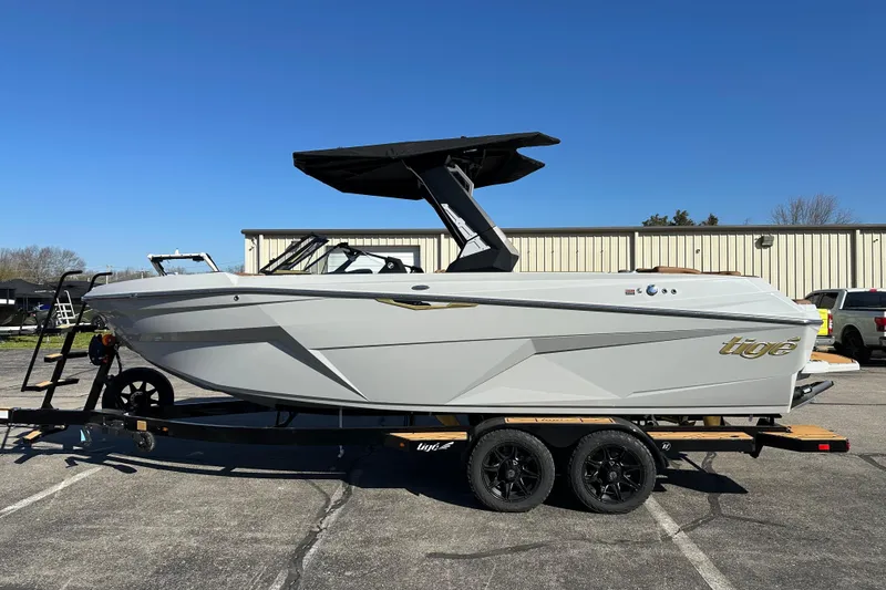 Slide: The Image of 2026 Tigé Z3 boat on trailer, sleek design, parked outdoors under clear blue sky. - 6