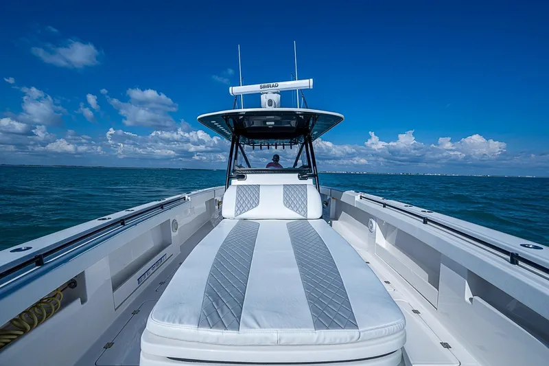 Slide: The Image of 2018 Invincible 40 Catamaran on open water, featuring sleek design and spacious deck. - 10