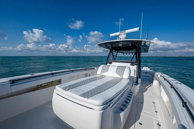 Slide: The Image of 2018 Invincible 40 Catamaran on open sea, featuring sleek design and spacious deck. - 11