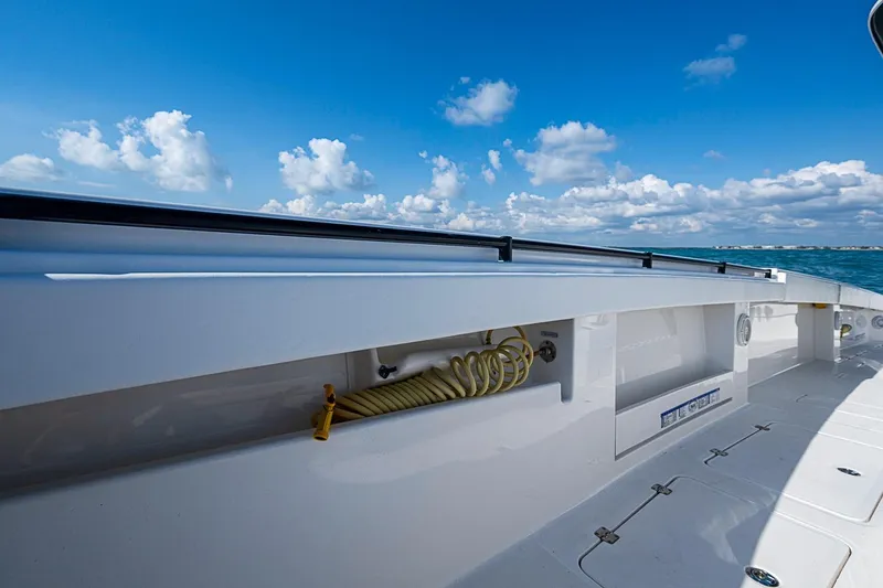 Slide: The Image of Invincible 40 Catamaran 2018 deck view with blue sky and ocean backdrop. - 12