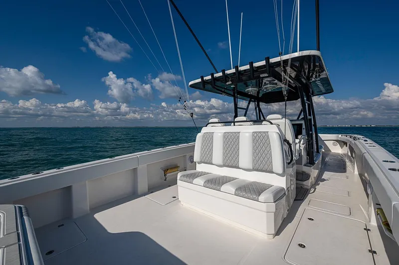 Slide: The Image of 2018 Invincible 40 Catamaran on open sea, featuring spacious seating and clear skies. - 18