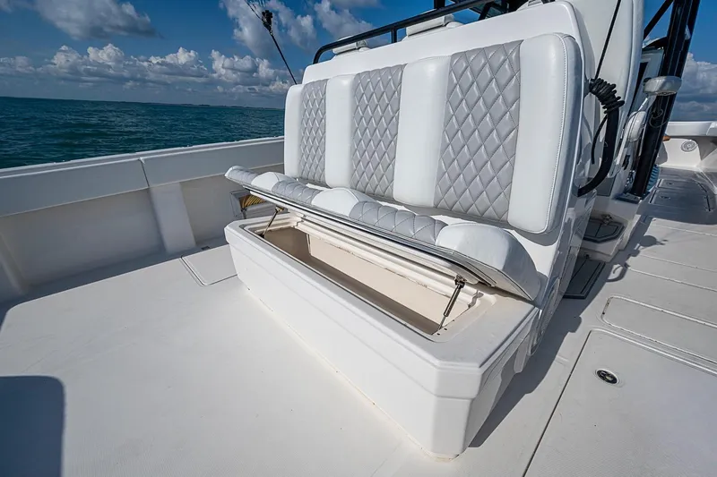 Slide: The Image of 2018 Invincible 40 Catamaran with open storage under cushioned seating on deck. - 19