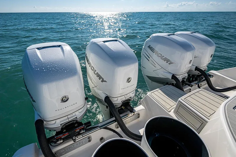 Slide: The Image of Four Mercury outboard engines on a 2018 Invincible 40 Catamaran in open water. - 20