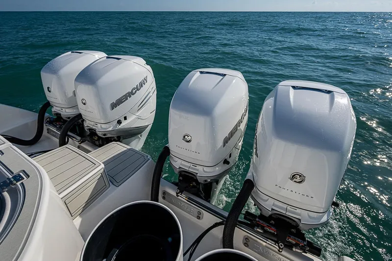 Slide: The Image of Four Mercury outboard engines on a 2018 Invincible 40 Catamaran in open water. - 22