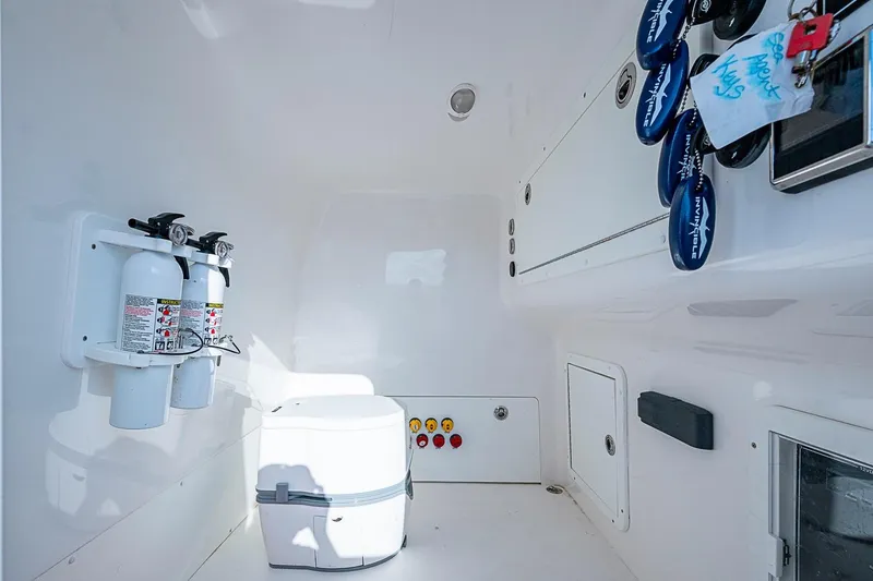 Slide: The Image of Interior of 2018 Invincible 40 Catamaran featuring fire extinguishers and storage compartments. - 23