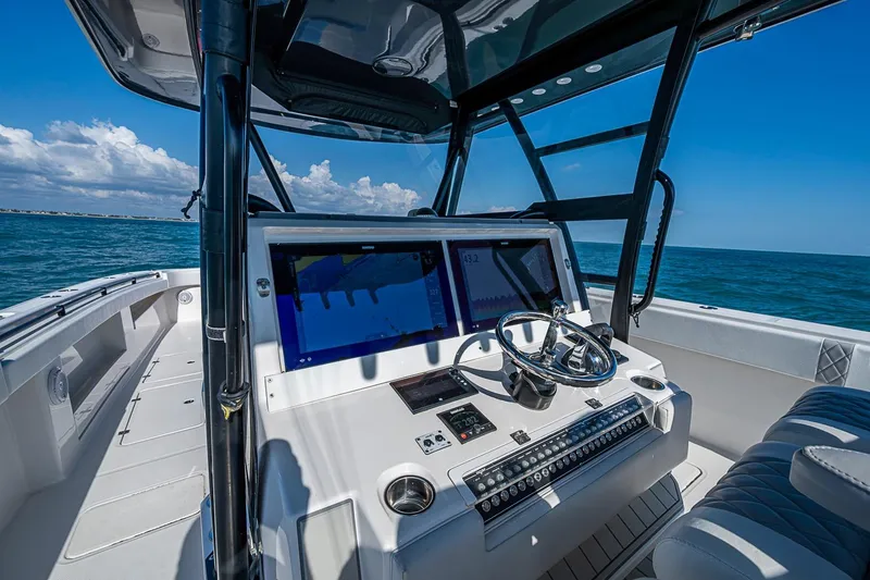 Slide: The Image of Cockpit view of 2018 Invincible 40 Catamaran on open sea, featuring modern navigation equipment. - 26