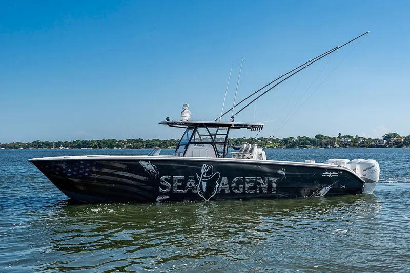 Slide: The Image of 2018 Invincible 40 Catamaran on water, featuring sleek design and fishing equipment. - 29