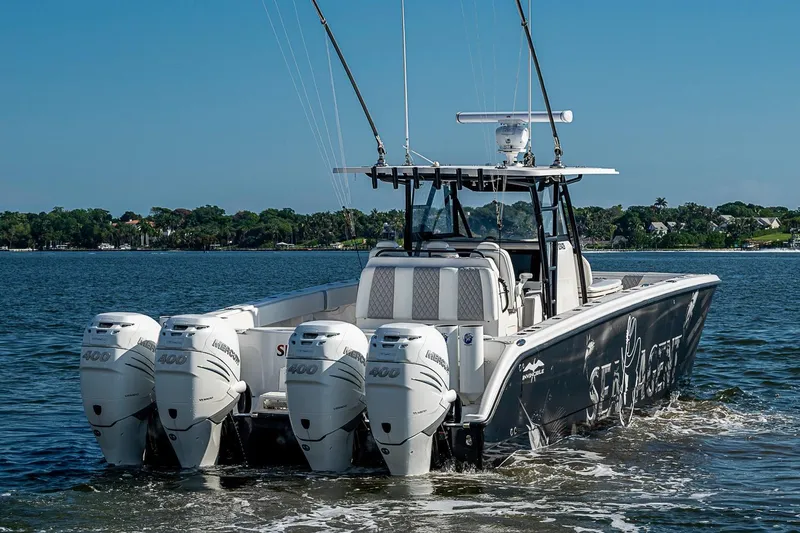 Slide: The Image of 2018 Invincible 40 Catamaran with four powerful outboard engines on the water. - 3