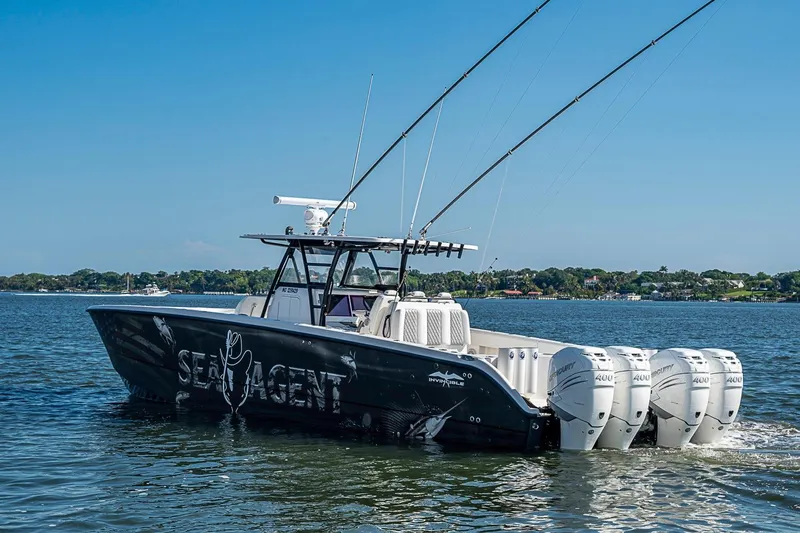 Slide: The Image of 2018 Invincible 40 Catamaran with four engines on a calm waterway. - 30