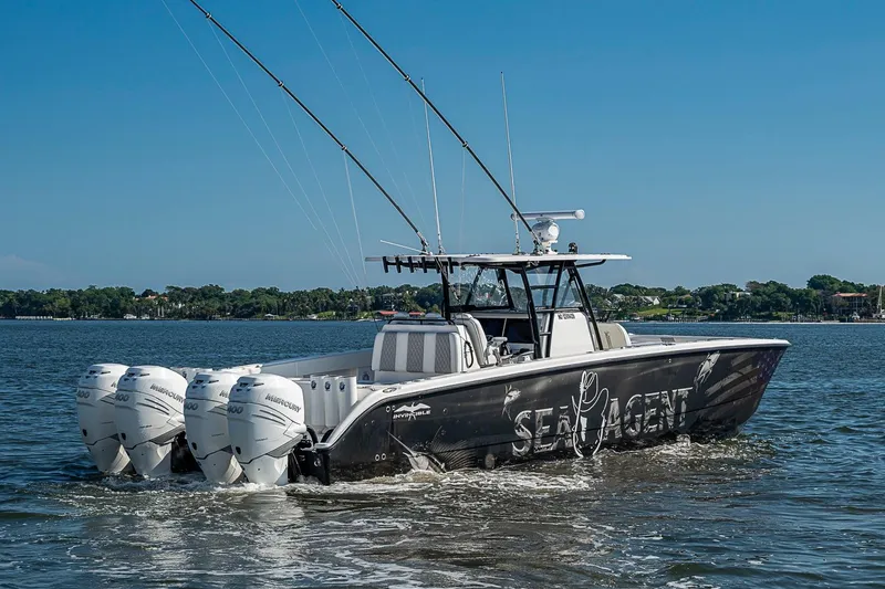 Slide: The Image of 2018 Invincible 40 Catamaran with four engines cruising on a sunny day. - 31