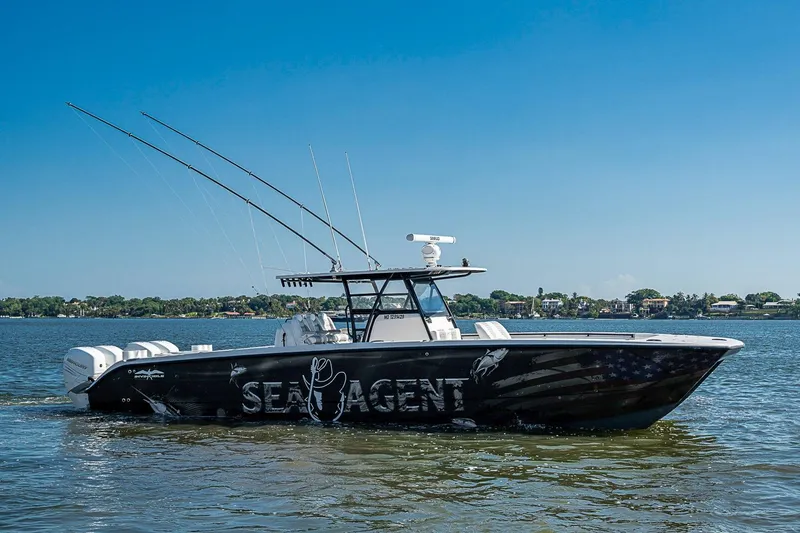 Slide: The Image of 2018 Invincible 40 Catamaran on water, featuring custom graphics and multiple outboard engines. - 33