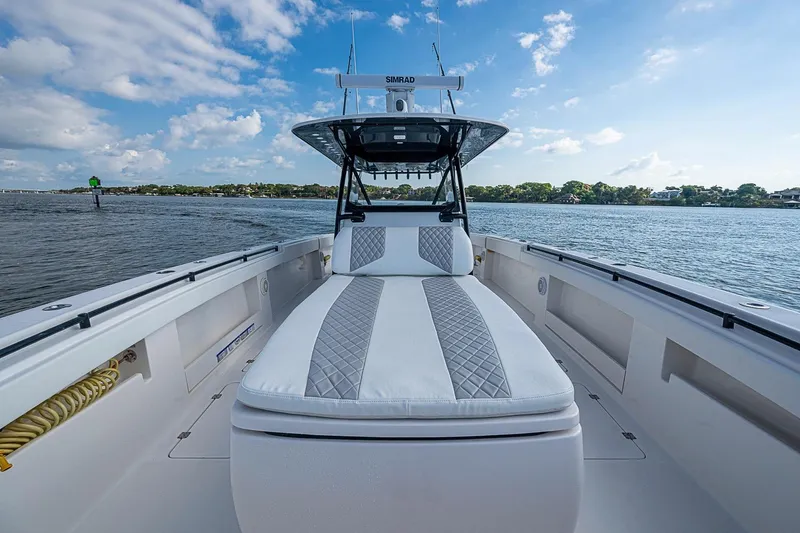 Slide: The Image of 2018 Invincible 40 Catamaran on water, featuring spacious deck and luxurious seating. - 6