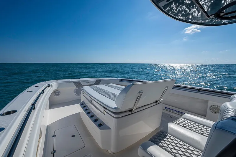 Slide: The Image of Invincible 40 Catamaran 2018 on open sea, featuring luxurious seating and clear blue skies. - 8