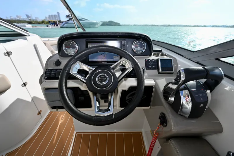 Slide: The Image of 2020 Crownline Eclipse E305 XS boat helm with modern controls and navigation system. - 13