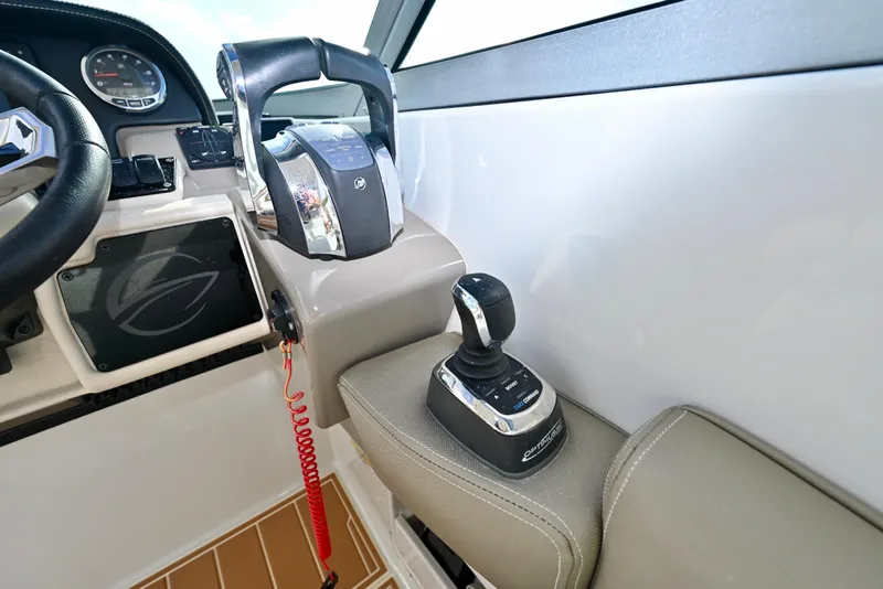 Slide: The Image of 2020 Crownline Eclipse E305 XS boat cockpit with steering and control panel. - 14