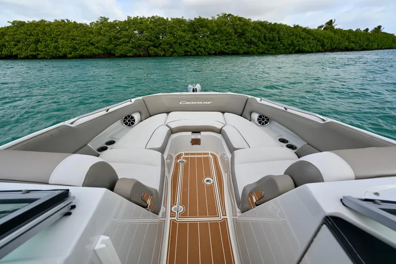 Slide: The Image of 2020 Crownline Eclipse E305 XS boat interior with luxurious seating on calm water. - 17