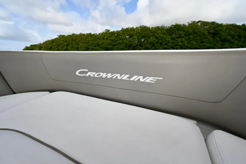 Slide: The Image of 2020 Crownline Eclipse E305 XS boat interior with logo, featuring sleek upholstery design. - 18