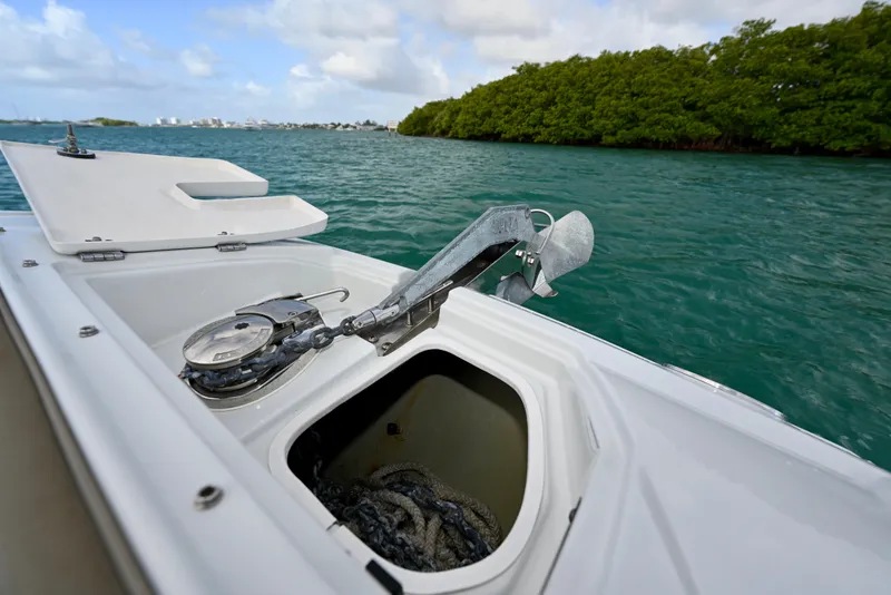 Slide: The Image of Anchor compartment of 2020 Crownline Eclipse E305 XS boat on water. - 19