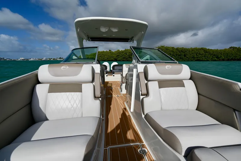 Slide: The Image of 2020 Crownline Eclipse E305 XS boat interior with luxurious seating on a sunny day. - 20