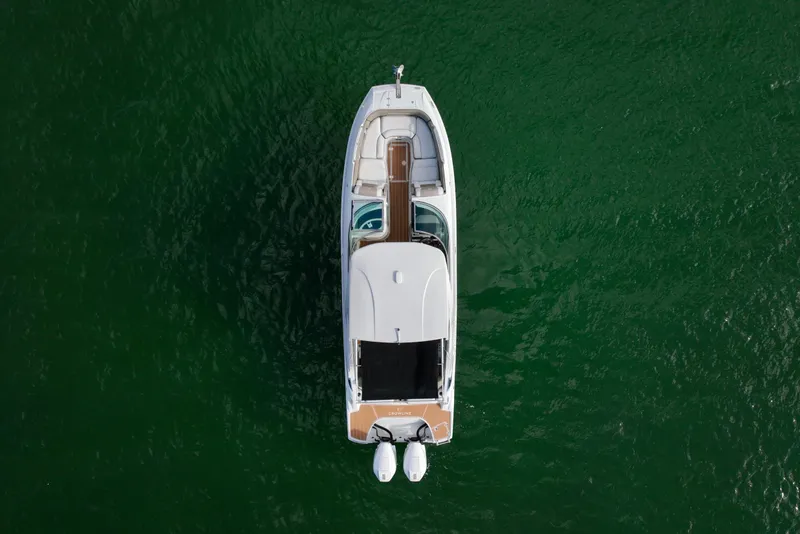 Slide: The Image of Aerial view of 2020 Crownline Eclipse E305 XS boat on green water. - 25