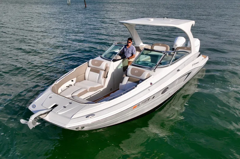 Slide: The Image of 2020 Crownline Eclipse E305 XS boat on water, featuring sleek design and spacious seating. - 4