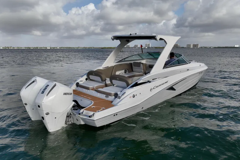 Slide: The Image of 2020 Crownline Eclipse E305 XS boat on water, featuring dual Mercury outboard engines. - 6