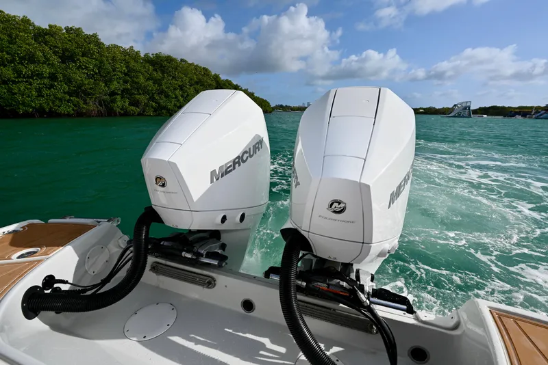 Slide: The Image of 2020 Crownline Eclipse E305 XS with dual Mercury outboard engines on turquoise water. - 7