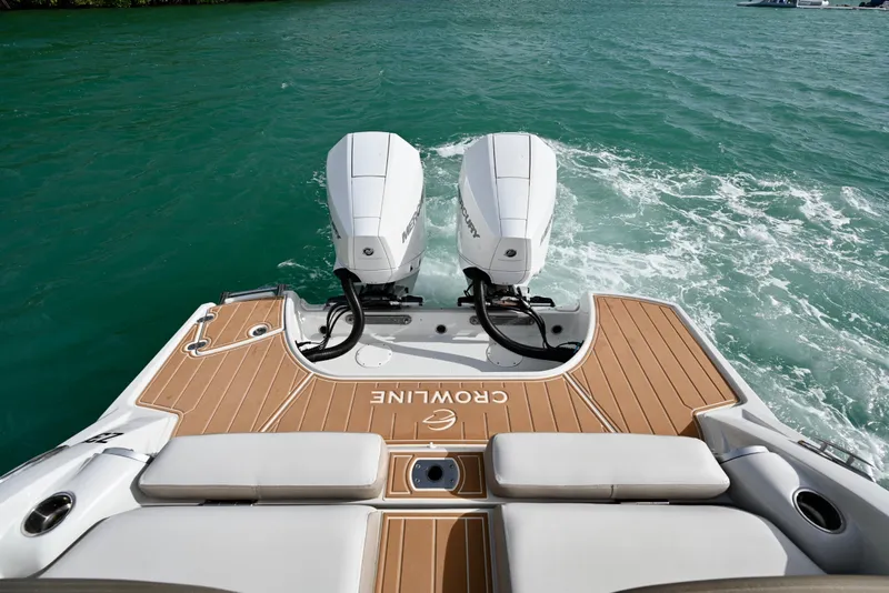 Slide: The Image of 2020 Crownline Eclipse E305 XS boat with dual Mercury outboard engines on turquoise water. - 8