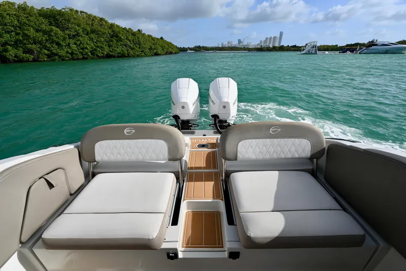Slide: The Image of 2020 Crownline Eclipse E305 XS boat with dual engines on turquoise water. - 9