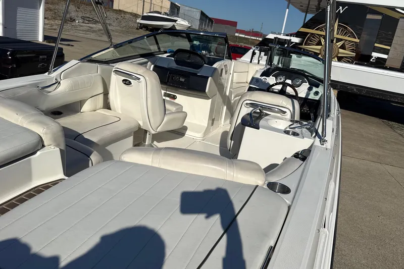 Slide: The Image of 2007 Sea Ray 250 Select EX boat interior with white seating and dashboard. - 11