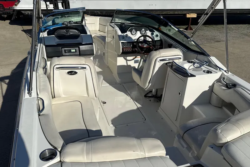 Slide: The Image of 2007 Sea Ray 250 Select EX boat interior with white seating and modern dashboard. - 12