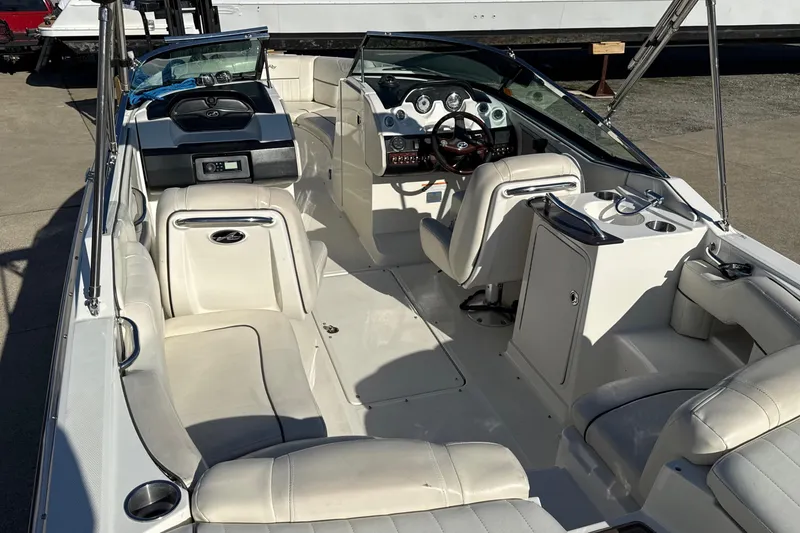 Slide: The Image of 2007 Sea Ray 250 Select EX boat interior with white seating and modern dashboard. - 13