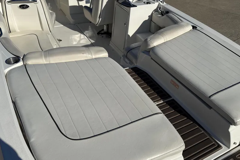 Slide: The Image of 2007 Sea Ray 250 Select EX boat interior with white cushioned seating and sleek design. - 14