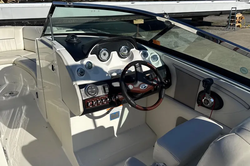 Slide: The Image of 2007 Sea Ray 250 Select EX boat interior with steering wheel and dashboard controls. - 15