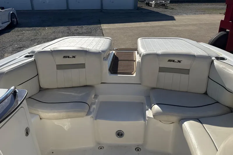 Slide: The Image of 2007 Sea Ray 250 Select EX boat interior with white seating and SLX branding. - 17