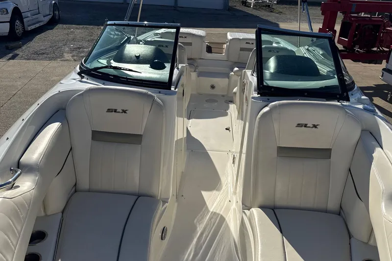 Slide: The Image of 2007 Sea Ray 250 Select EX boat interior with white leather seating and windshield. - 19
