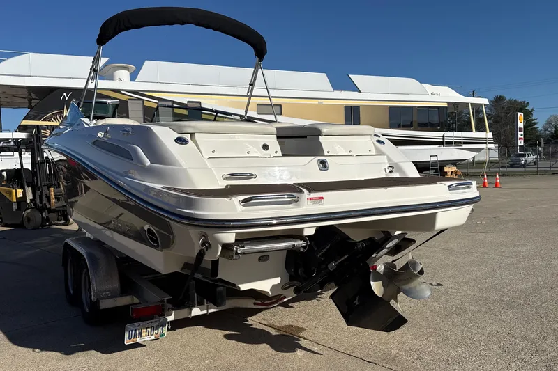Slide: The Image of 2007 Sea Ray 250 Select EX boat on trailer, parked outdoors under clear blue sky. - 4