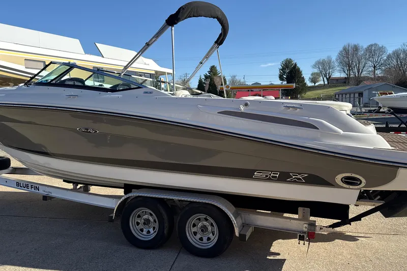 Slide: The Image of 2007 Sea Ray 250 Select EX boat on trailer, parked outdoors under clear sky. - 5