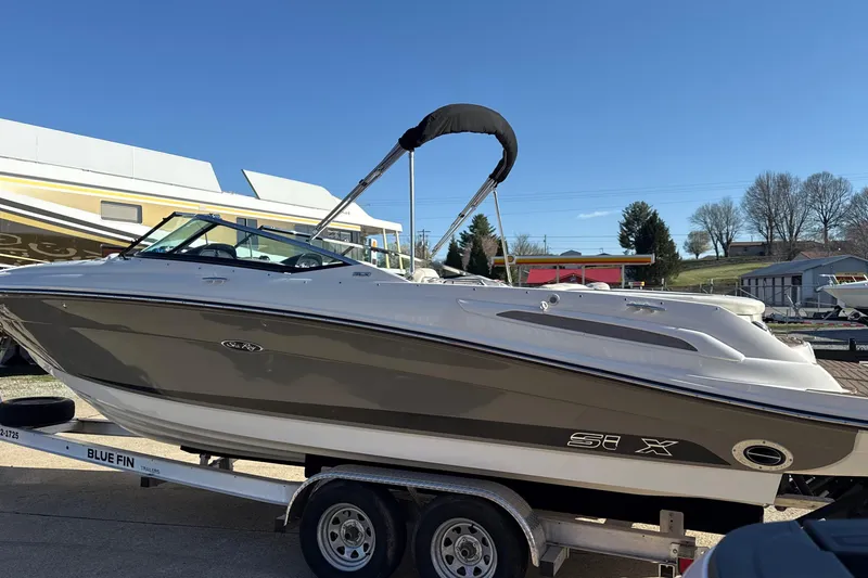 Slide: The Image of 2007 Sea Ray 250 Select EX boat on trailer under clear blue sky. - 6